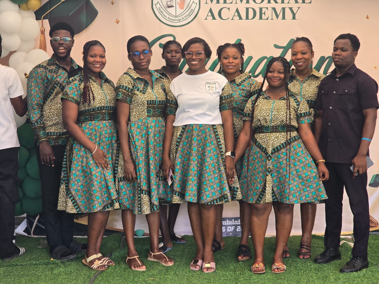 Teaching staff in matching print outfits on graduation day